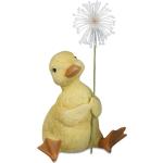 dekojohnson lustiges Deko-Enten-Küken mit Puste-Blume Gänseküken Deko-Vogel Funny Bird Tischdeko Osterdeko gelb sitzend 9x9x14cm Tierfigur