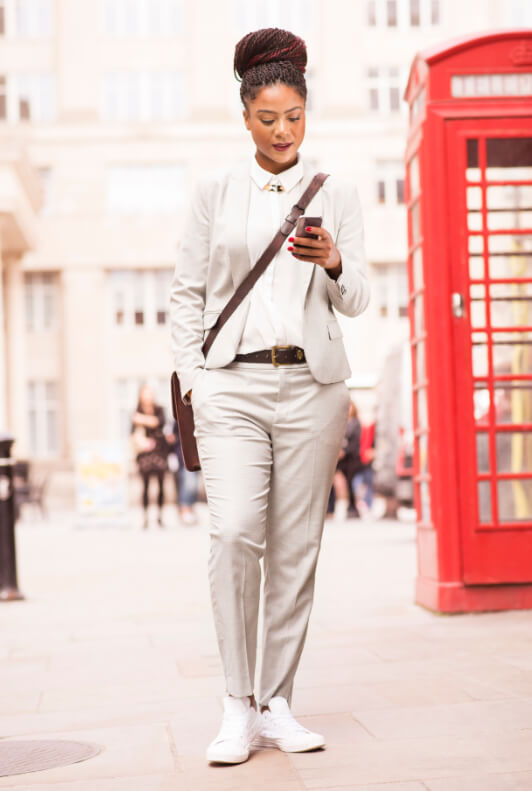 Street Style: Frau mit weißem Power Suit und weißen Sneakern