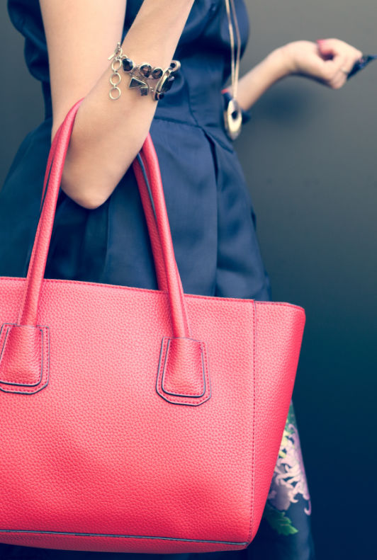 Frau mit pinkfarbener Handtasche